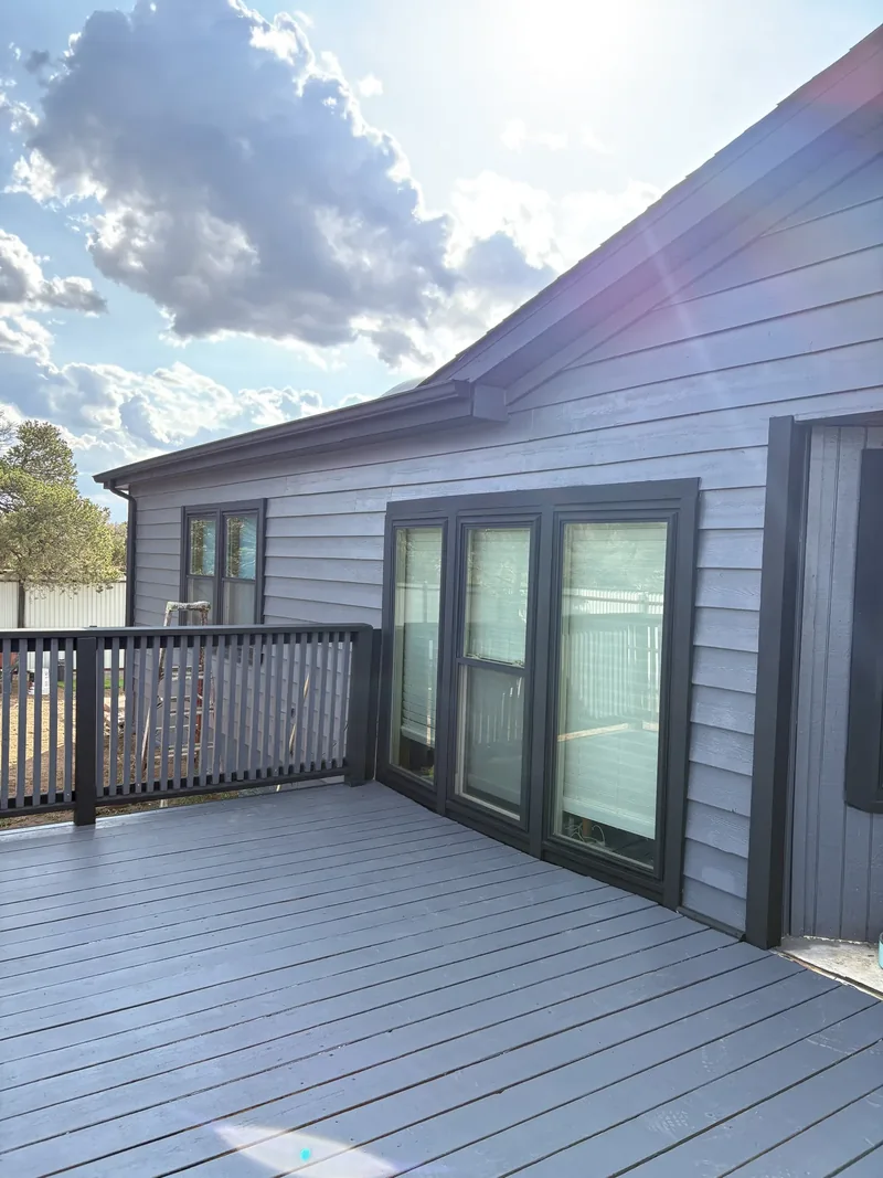 Weathered cedar deck power washed, sanded, and re-stained to like-new