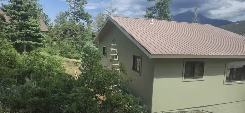 Two-story home exterior freshly repainted against the foothills
