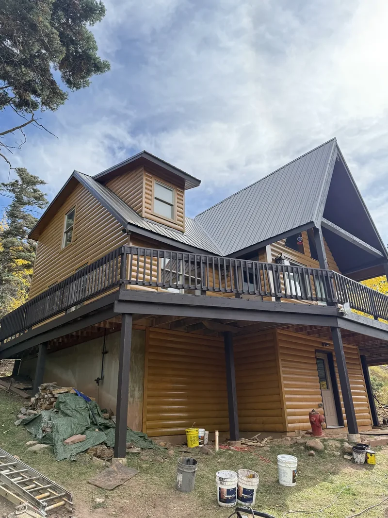 Log home with a fresh coat of stain drying on the timber and deck
