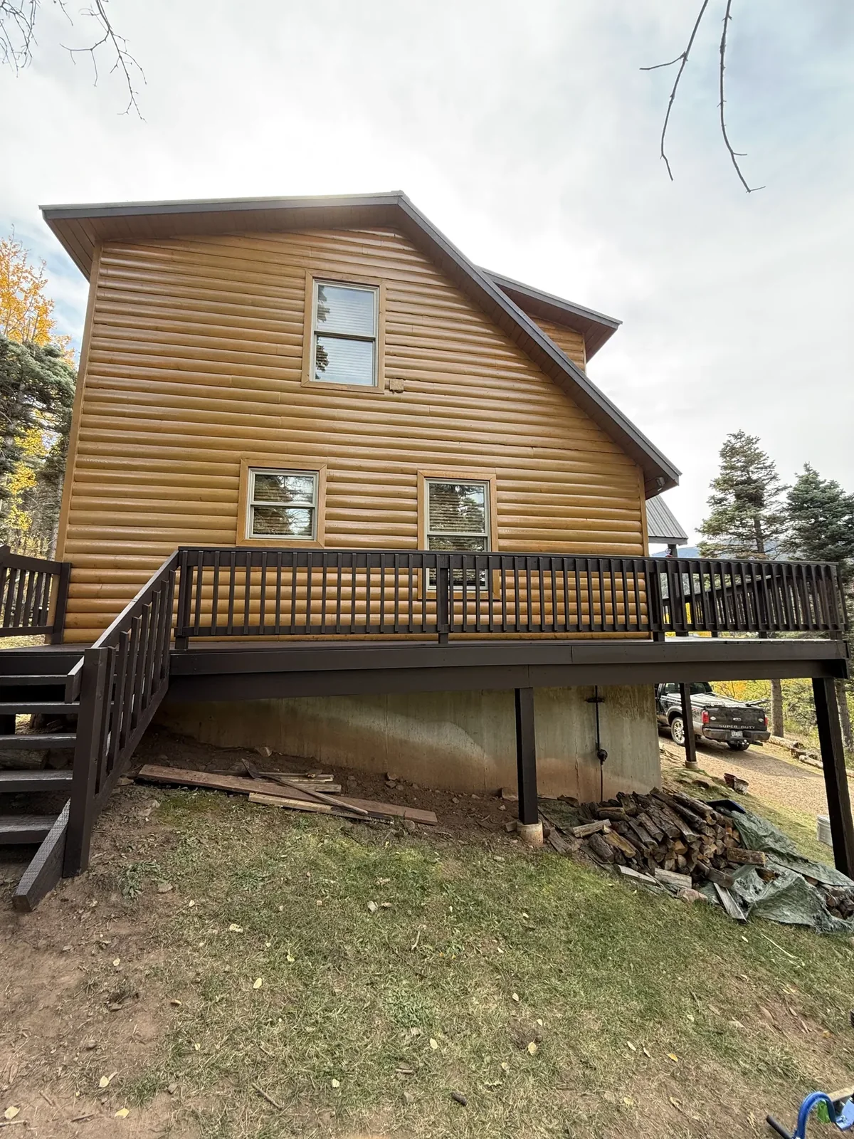 Log home after restoration, freshly stained, protected timber