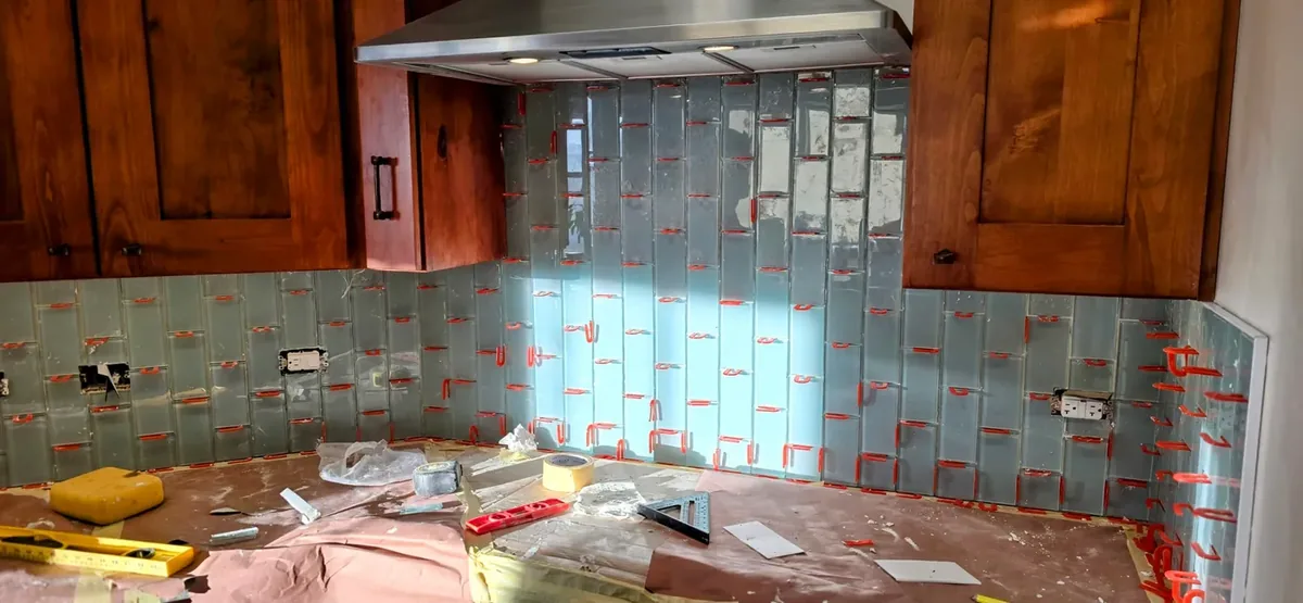 Kitchen tile backsplash set clean around outlets by SBJ Painting